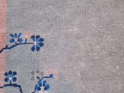 Top of lower left corner showing wear in rug